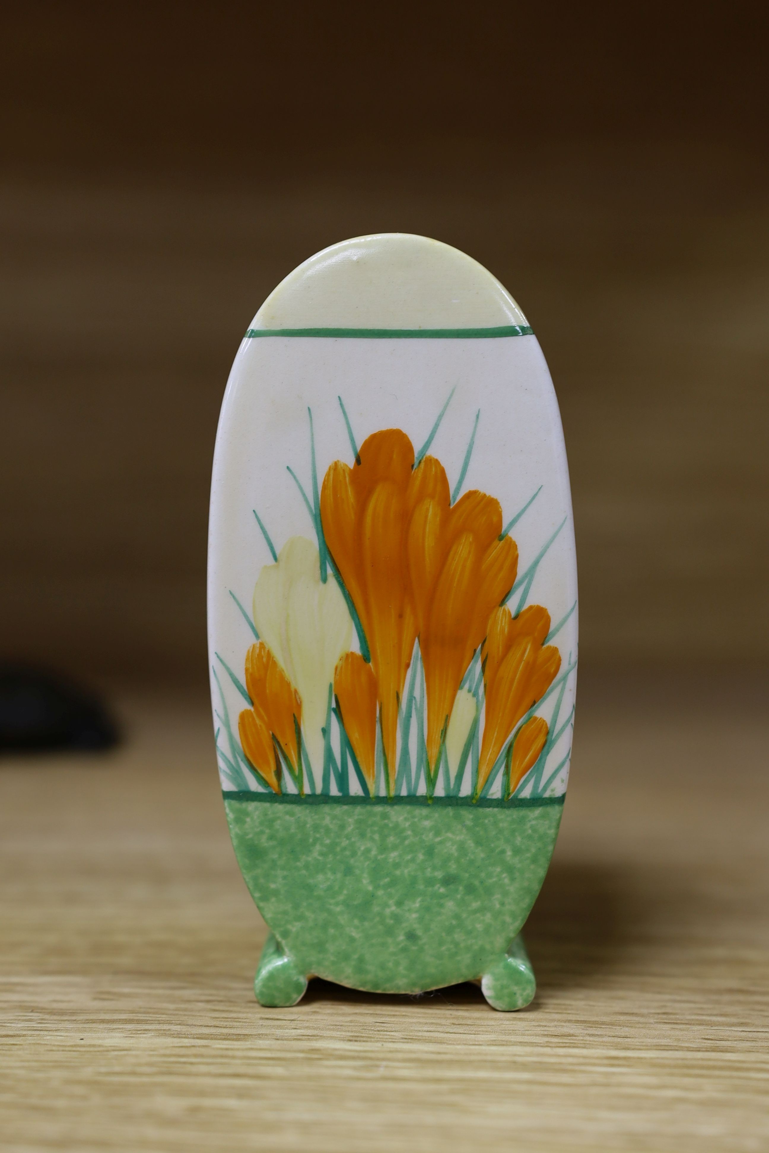 A Clarice Cliff sungleam crocus jam pot and cover, a sugar shaker and a Dutch clog ornament (3), jam pot and cover 10 cms high